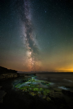 The Milky Way over a rocky stretch of shoreline on southern &Ouml;land