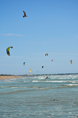 Kitesurfers rushing along the waves of the Atlantic Ocean. Saint-Pierre-Quiberon‎, Brittany. France