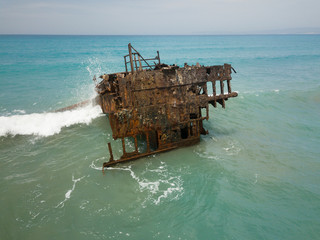 Rusty ship wreck surrounded by green sea, Cyprus