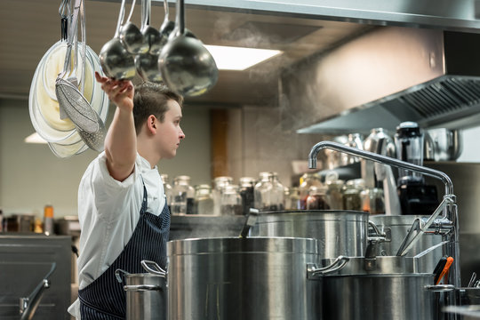 Dedicated master chef preparing high quality food in a contemporary commercial kitchen
