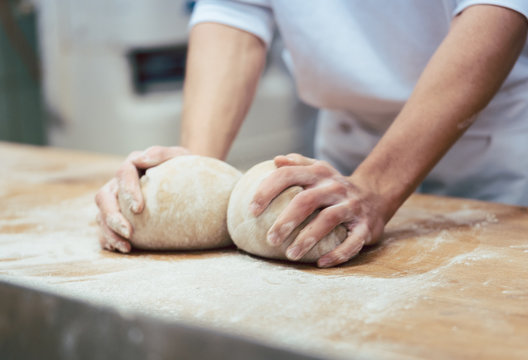 Baker forming breads from dough