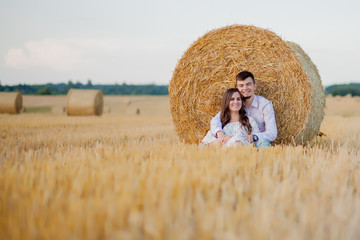 Naklejka na ściany i meble Happy young couple on straw, romantic people concept, beautiful landscape, summer season