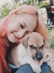 Portrait girl selfie with her puppy on nature background.