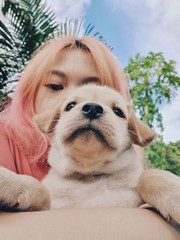 Portrait girl selfie with her puppy on nature background.