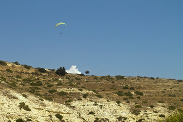 Paraglider in the sky above a mountain slope