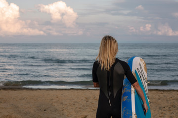 Girl surfer on the beach