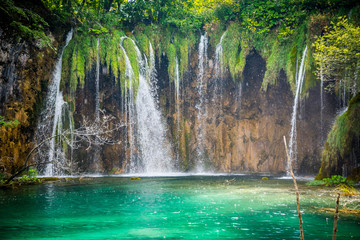 Amazing waterfalls with crystal clear water in the forest in Plitvice lakes National Park, Croatia. Nature landscape