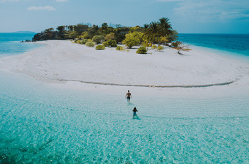 Couple spending time on a beutiful remote tropical island in the philippines. Concept about vacation and lifestyle.