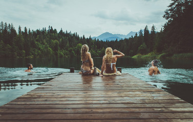 Group of friends having fun at the lake in the morning