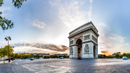 Paris Triumphal Arch the Arc de Triomphe de l’Etoile at the western end of the Champs-Elysees at the centre of Place Charles de Gaulle, France. Early morning with nice sunrise light - obrazy, fototapety, plakaty