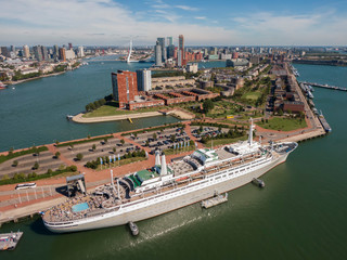 aerial of SS Rotterdam ship moared on Katendrecht land head with skyline of towers and Erasmus...