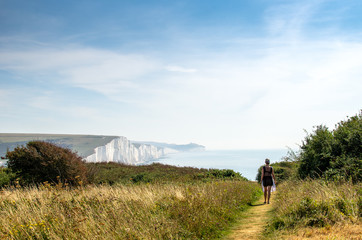 Obraz premium Woman on a footpath at Seven Sisters White Cliffs, England