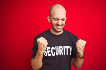 Young safeguard man wearing security uniform over red isolated background very happy and excited...