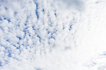 Blue sky on a sunny day with fluffy clouds