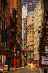 Obraz premium Narrow street of Wall Street District in New York City