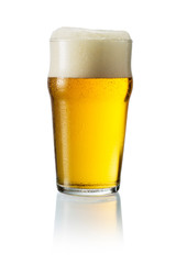 Glass of blonde beer with foam