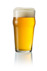 Glass of blonde beer with foam