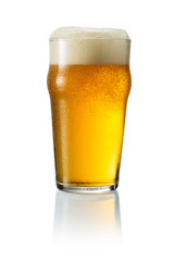 Glass of blonde beer with foam