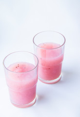 Drinking yogurt in a glass on a white background, copy space. Delicious pink fruit yogurt. Natural detoxification. Healthy eating concept. Fresh homemade yogurt for Breakfast. Fruit yogurt smoothie.