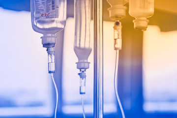 slow intravenous drug administration system, hospital ward, soft focus.