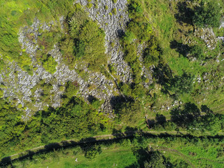 Aerial view on Irish landscape, Green fields, cloudy sky, black bales with hay, Country side, County Galway.