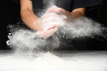 Fototapeta premium Clap hands of baker with flour