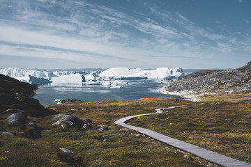 View towards Icefjord in Ilulissat. Easy hiking route to the famous Kangia glacier near Ilulissat in Greenland. The Ilulissat Icefjord seen from the viewpoint. Ilulissat Icefjord was declared a UNESCO