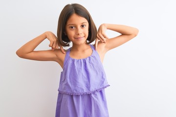 Young beautiful child girl wearing purple casual dress standing over isolated white background looking confident with smile on face, pointing oneself with fingers proud and happy.
