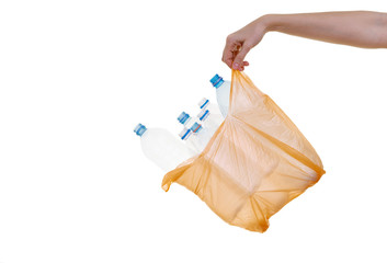 hand holding plastic bag with plastic bottles on isolated background