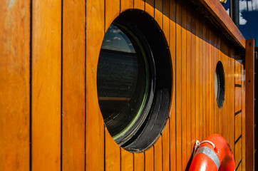 Two portholes on a wooden tall ship cabin