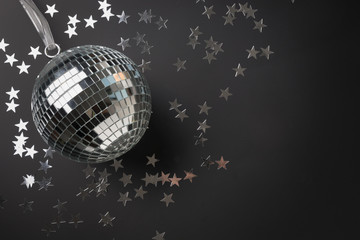 Silver mirror disco ball glitter with stars on black background. Festive holiday backdrop. Xmas pattern with copy space. Black friday.
