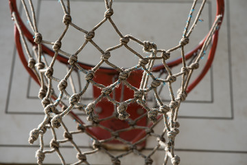 Fototapeta na wymiar Basketball hoop and net made out of rope with white backboard