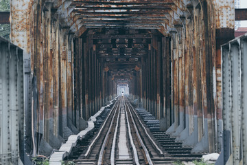 Iron railway bridge point perspective with a human silhouette in the center in Hanoi, Vietman