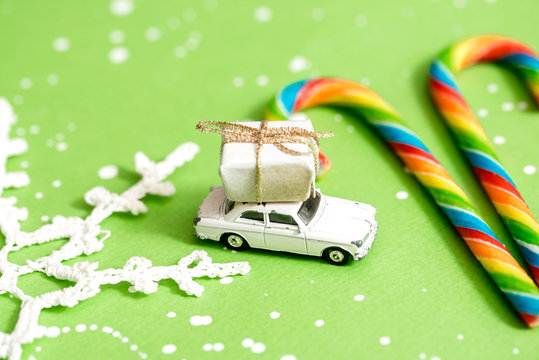 Christmas Tree with Snowman on Red Toy Car with Candy Canes on the Background, Merry Christmas Concept, Free Space for Text