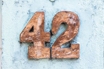 Street number sign on the wall 42