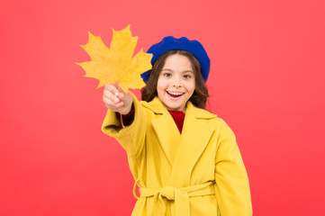 So beautiful. school time. childhood happiness. parisian girl child in french beret and yellow coat. happy little girl with maple leaf. fall season. fallen leaves bunch. autumn kid fashion