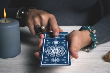 Tarot cards in fortune teller hands concept.