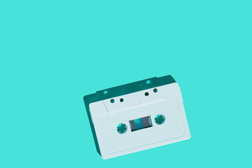Fototapeta premium Audio cassette on colored background. White audio cassette tape. Vintage disco poster. Pattern of audio cassete