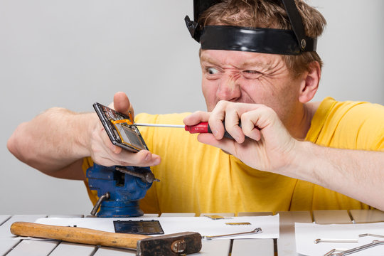 Man repairing cell phone