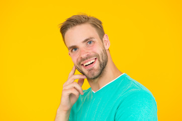 Barber hairdresser salon. Bearded man. Skin care. Facial care. Keep youth. Kind smile. Self care. Handsome man yellow background. Well groomed guy with bristle and nice hairstyle. Male beauty
