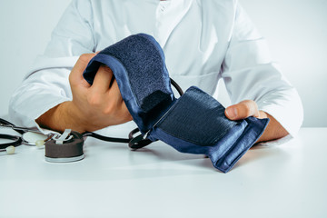 A doctor is doing a blood pressure monitor. Medical and pharmaceutical concept. Blood pressure test, hypertension problems, treatment. Heart attack, blood clots.