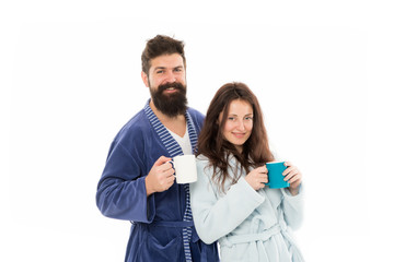 Caffeine power concept. Couple enjoy lazy weekend and drink coffee. Wife and husband bathrobes hold tea mug coffee cup. With coffee morning tastes better. Couple relax in morning with coffee