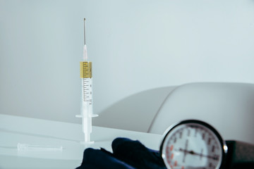 The syringe filled with drugs is lying on the table. Medical and pharmaceutical concept. Drug overdose, problems with drug abuse.