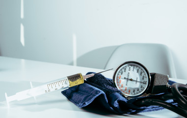 The syringe filled with drugs is lying on the table. Medical and pharmaceutical concept. Drug overdose, problems with drug abuse.