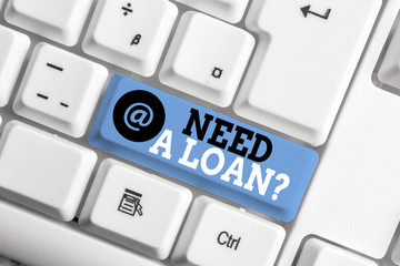 Text sign showing Need A Loan Question. Business photo showcasing asking he need money expected paid back with interest White pc keyboard with empty note paper above white background key copy space