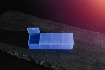 Blue medication box. Medical and pharmaceutical concept. Help in taking medicine, regularity. Problems with organization, cure sick people.