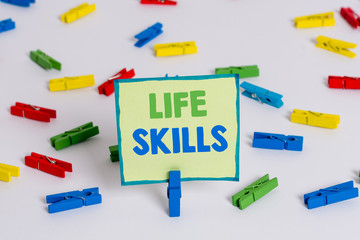 Conceptual hand writing showing Life Skills. Concept meaning skill that is necessary for full participation in everyday life Colored clothespin papers empty reminder white floor office