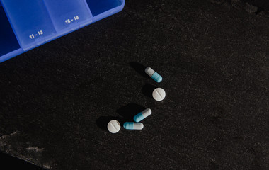 Blue medication box. Medical and pharmaceutical concept. Help in taking medicine, regularity. Problems with organization, cure sick people.