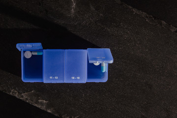 Blue medication box. Medical and pharmaceutical concept. Help in taking medicine, regularity. Problems with organization, cure sick people.