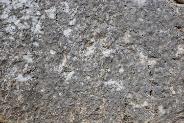 The ancient megalithic walls surround the acropolis of Amelia, in Umbria, Italy. Texture composed of huge blocks of stone, with irregular boulders interlocked together.